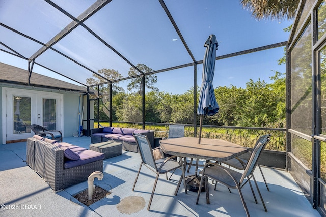 view of patio / terrace with a lanai, an outdoor hangout area, and french doors