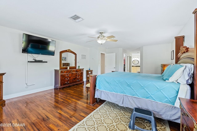 bedroom with ceiling fan, ensuite bathroom, and dark hardwood / wood-style floors