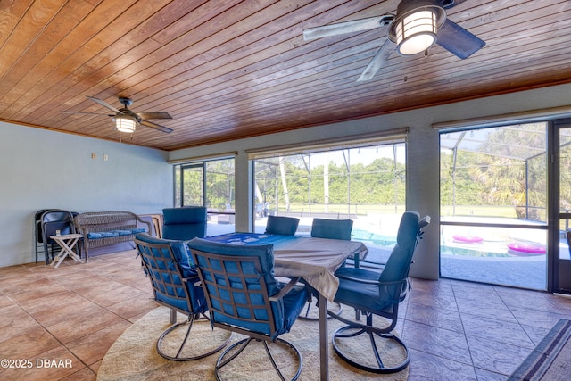 sunroom with ceiling fan and wooden ceiling