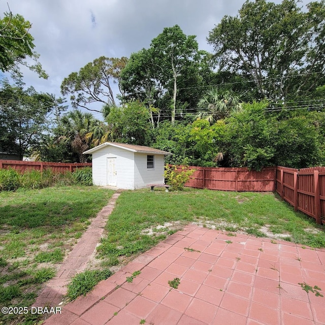 2344 Florida Blvd, South Daytona, FL 32119 - fenced backyard featuring a patio, an outbuilding, and view of wooded area