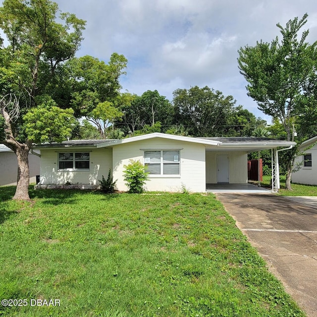 2344 Florida Blvd, South Daytona, FL 32119 - view of front of home featuring concrete driveway, a front lawn, and an attached carport