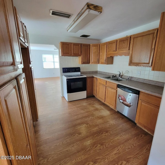 2344 Florida Blvd, South Daytona, FL 32119 - kitchen with range with electric cooktop, dishwasher, light wood finished floors, tasteful backsplash, and light countertops