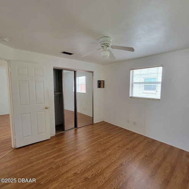 2344 Florida Blvd, South Daytona, FL 32119 - unfurnished bedroom featuring a closet, light wood-type flooring, and a ceiling fan