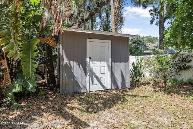 view of shed featuring fence