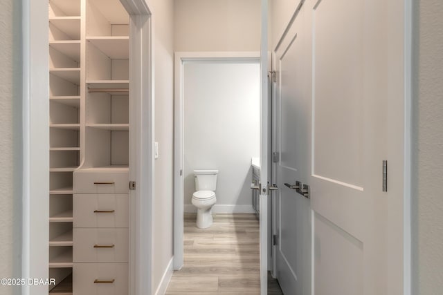 bathroom featuring wood-type flooring and toilet