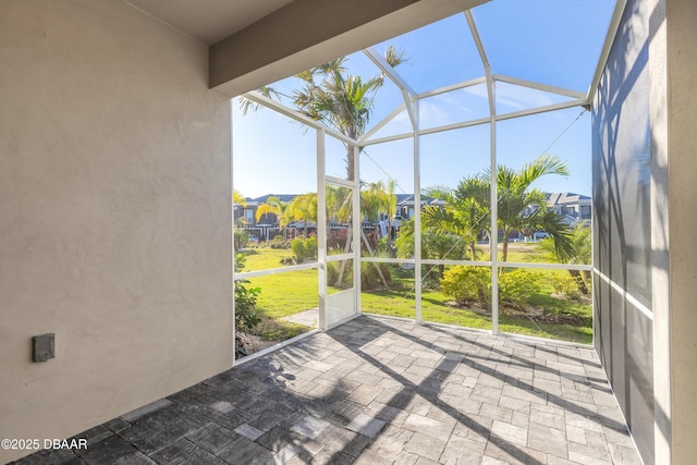 unfurnished sunroom with plenty of natural light