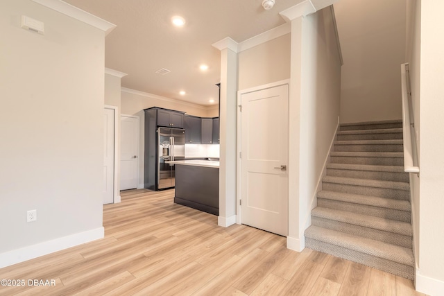 stairway with hardwood / wood-style flooring and crown molding