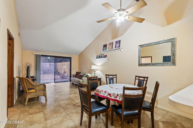 dining space with lofted ceiling, ceiling fan, and light tile patterned flooring