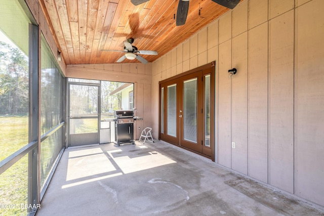 unfurnished sunroom featuring ceiling fan, lofted ceiling, and wood ceiling