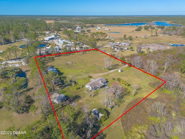 birds eye view of property featuring a water view and a rural view