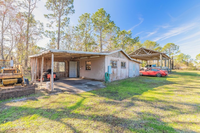 view of side of property with a lawn and a carport