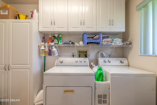 laundry area with cabinets and washing machine and dryer