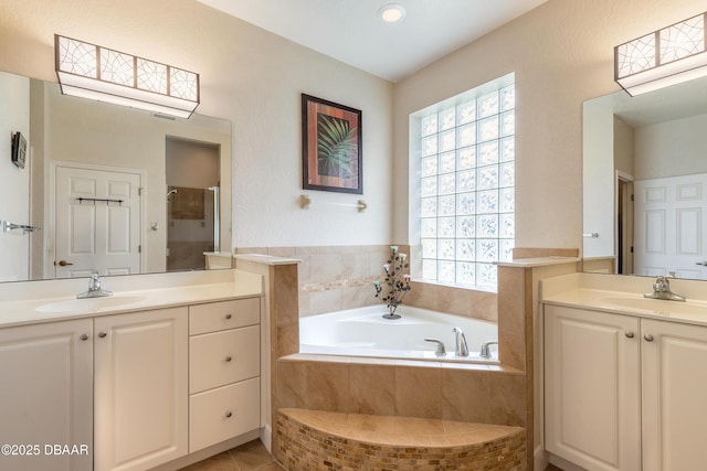 59 Westland Run, Ormond Beach, FL 32174 - bathroom with plenty of natural light, two vanities, a garden tub, and a shower stall