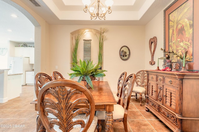 59 Westland Run, Ormond Beach, FL 32174 - dining room featuring arched walkways, light tile patterned flooring, a chandelier, a tray ceiling, and recessed lighting
