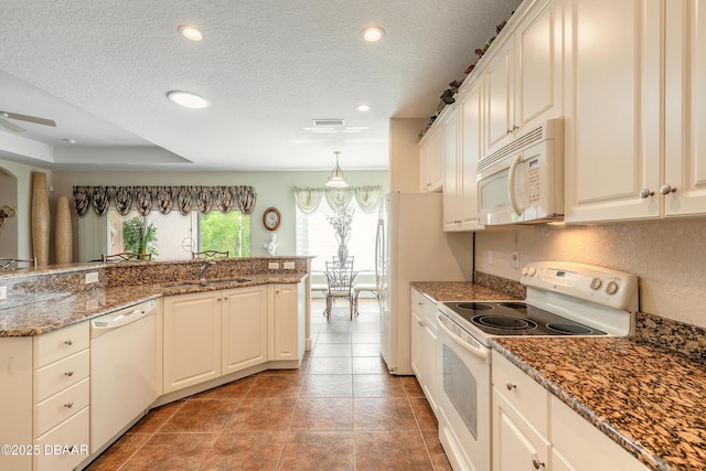 59 Westland Run, Ormond Beach, FL 32174 - kitchen featuring white appliances, a textured ceiling, a sink, recessed lighting, and decorative light fixtures