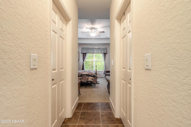 59 Westland Run, Ormond Beach, FL 32174 - corridor with a textured wall, dark tile patterned floors, and dark colored carpet