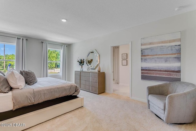 carpeted bedroom featuring a textured ceiling