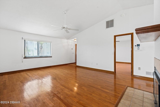 empty room featuring ceiling fan, hardwood / wood-style floors, and vaulted ceiling