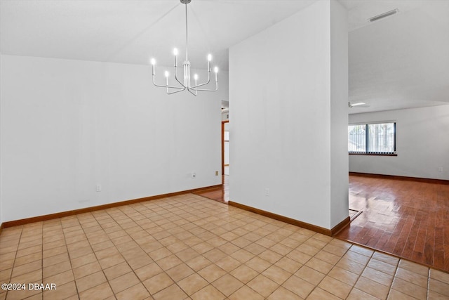 unfurnished dining area featuring lofted ceiling, light wood-type flooring, and an inviting chandelier