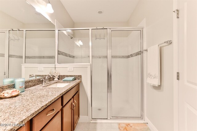 bathroom with vanity, tile patterned flooring, and a shower with shower door