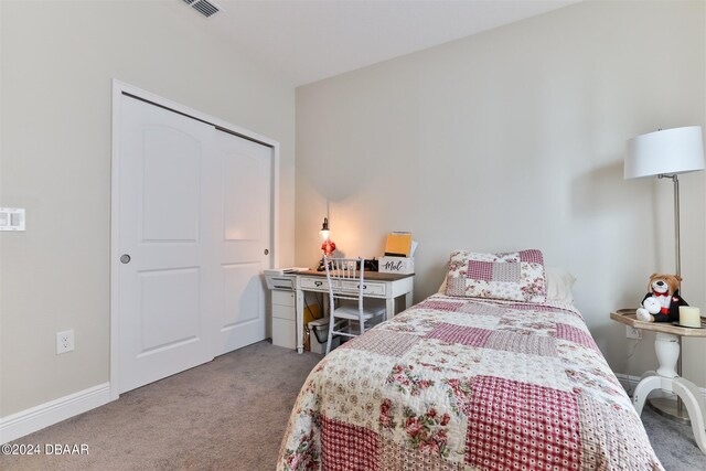 carpeted bedroom with a closet