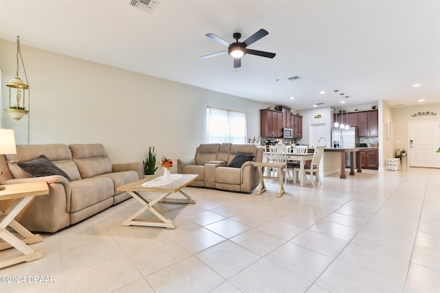 living room with light tile patterned floors and ceiling fan