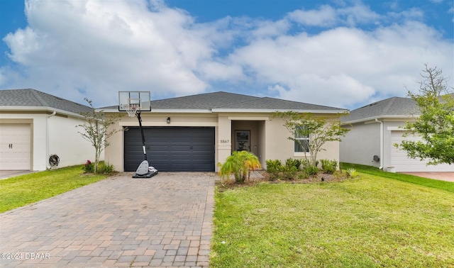 view of front of house with a garage and a front lawn