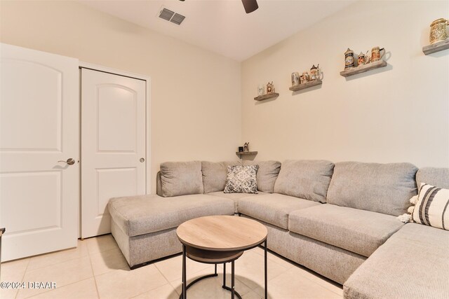 living room featuring light tile patterned floors and ceiling fan