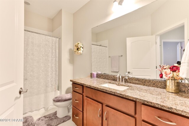 full bathroom featuring tile patterned flooring, vanity, toilet, and shower / bathtub combination with curtain