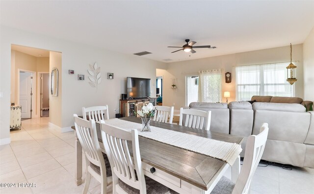 tiled dining area with ceiling fan