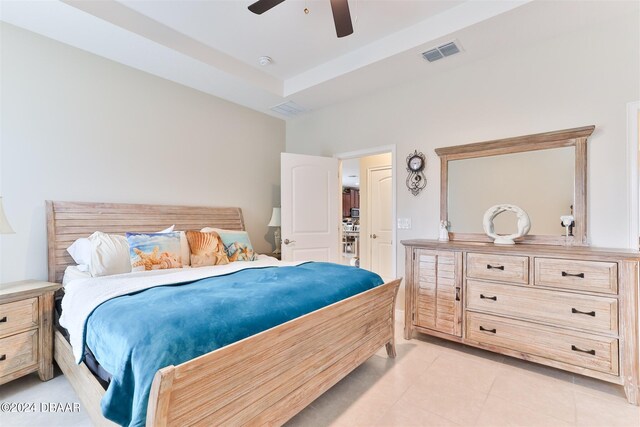 tiled bedroom featuring ceiling fan