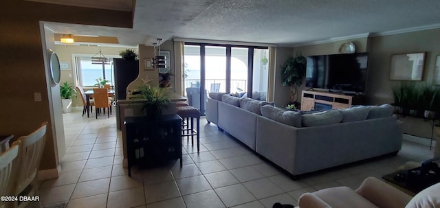 living room with plenty of natural light, light tile patterned floors, a textured ceiling, and ornamental molding