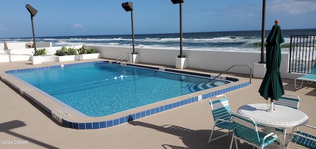 view of pool with a water view