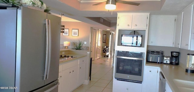 kitchen with light tile patterned floors, a ceiling fan, light countertops, white cabinets, and appliances with stainless steel finishes