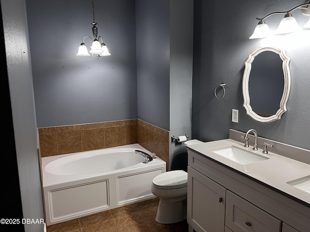 full bathroom with a garden tub, double vanity, toilet, an inviting chandelier, and a sink