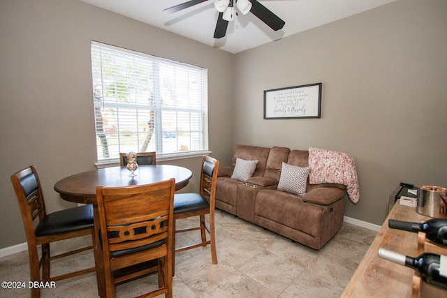 dining room featuring a ceiling fan and baseboards