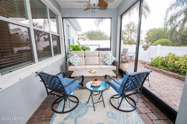 sunroom with ceiling fan