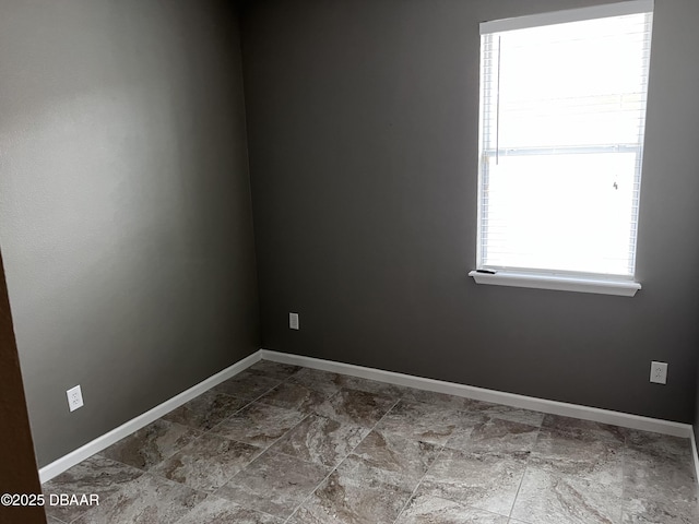 spare room with baseboards