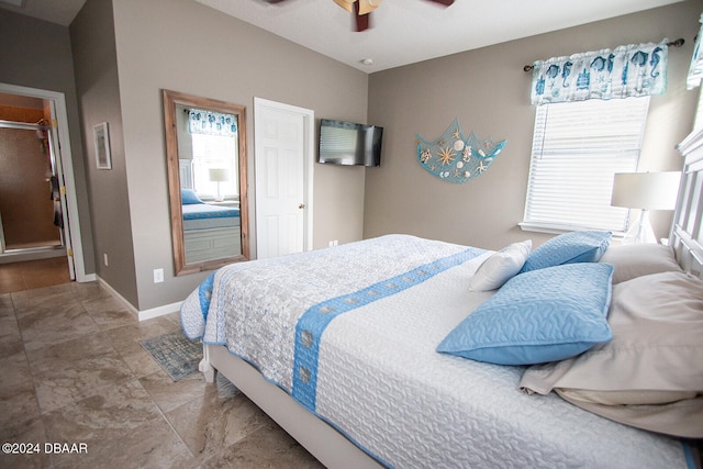 bedroom featuring multiple windows, baseboards, and a ceiling fan