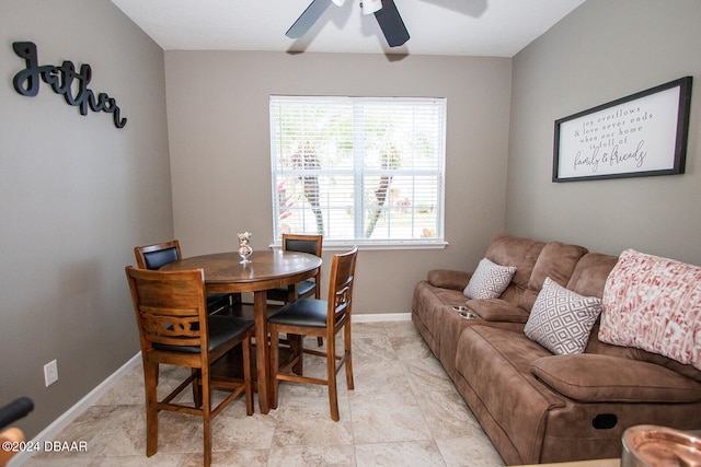 dining area with ceiling fan and baseboards