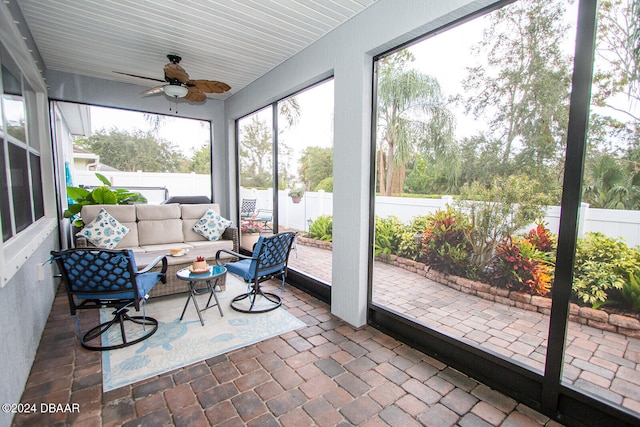 sunroom with a ceiling fan