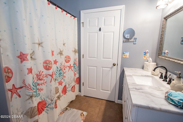 bathroom with a shower with curtain, vanity, and tile patterned flooring