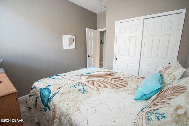 carpeted bedroom with a closet, visible vents, and baseboards