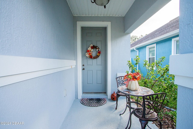 entrance to property featuring stucco siding