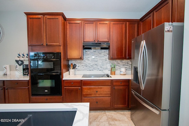 kitchen with black appliances and tasteful backsplash