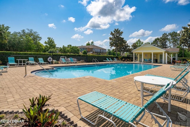 pool with fence and a patio