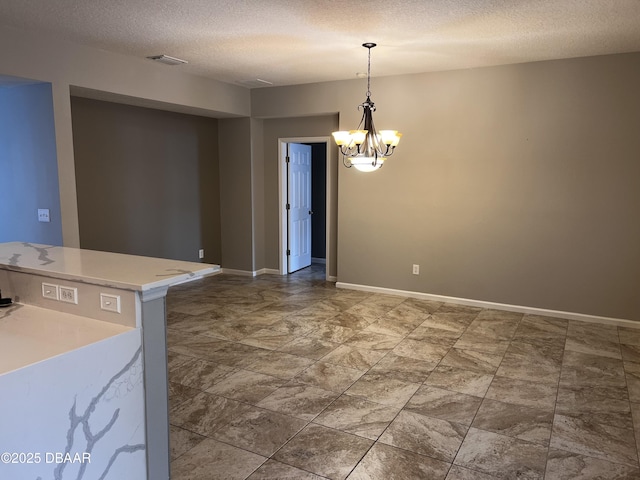 unfurnished dining area featuring a chandelier, visible vents, a textured ceiling, and baseboards