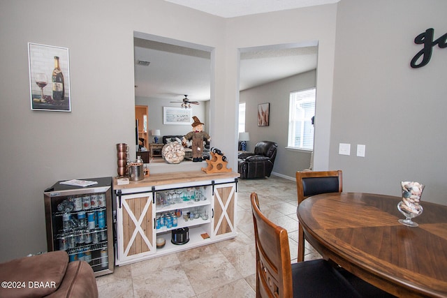 dining room featuring a ceiling fan and baseboards