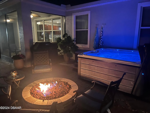 view of patio featuring an outdoor fire pit and a hot tub