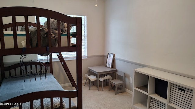 bedroom featuring light carpet and multiple windows